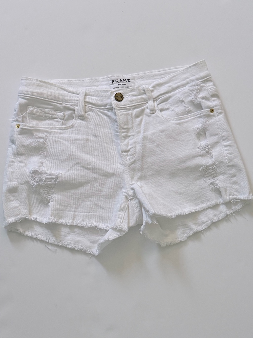 FRAME Denim "Le Cutoff" white distressed denim shorts distressed raw frayed hem